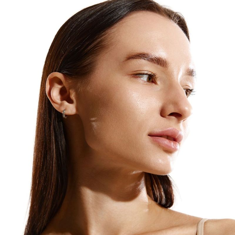 Woman with long hair and natural makeup.
