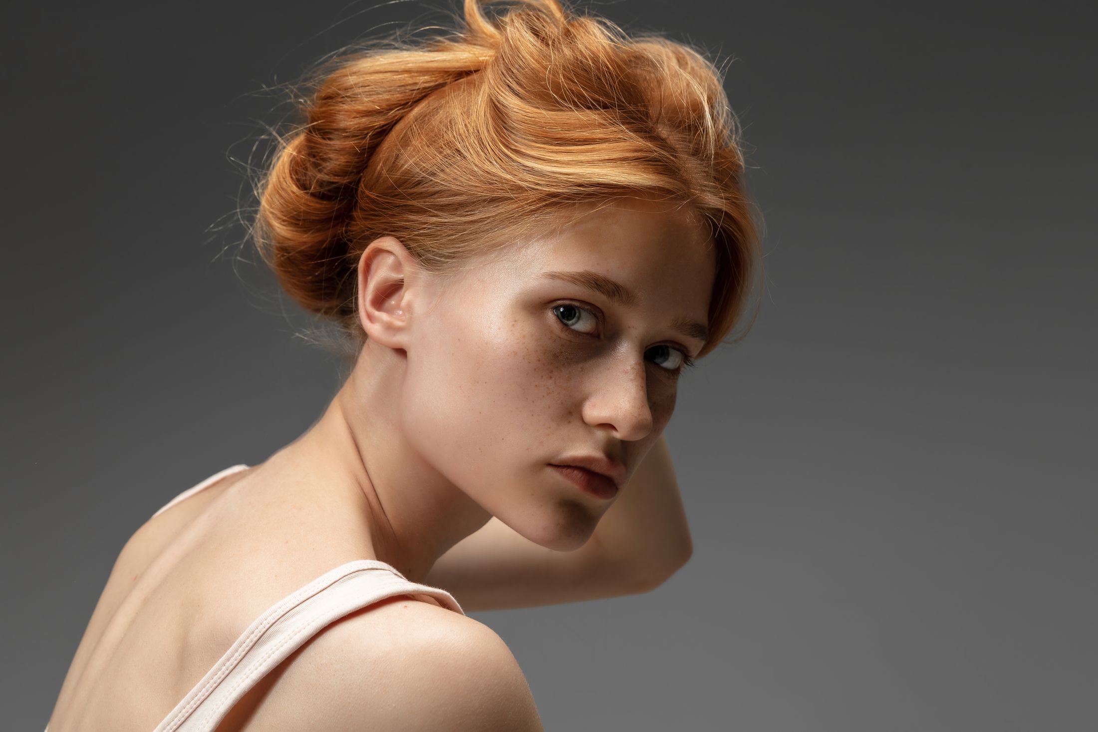 Profile of a young woman with red hair.